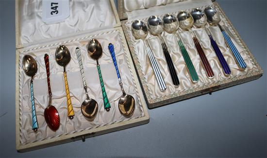 Two cased sets of six Danish silver and enamel coffee spoons, one set by Michelsen.